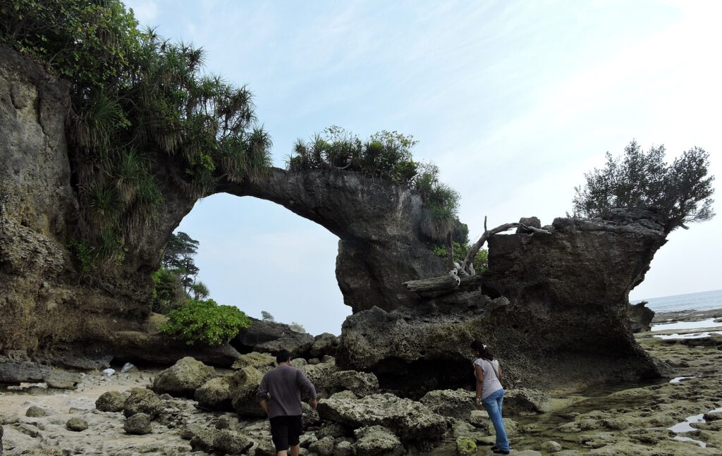 Natural Bridge on Neil Island surrounded by coral rocks at low tide